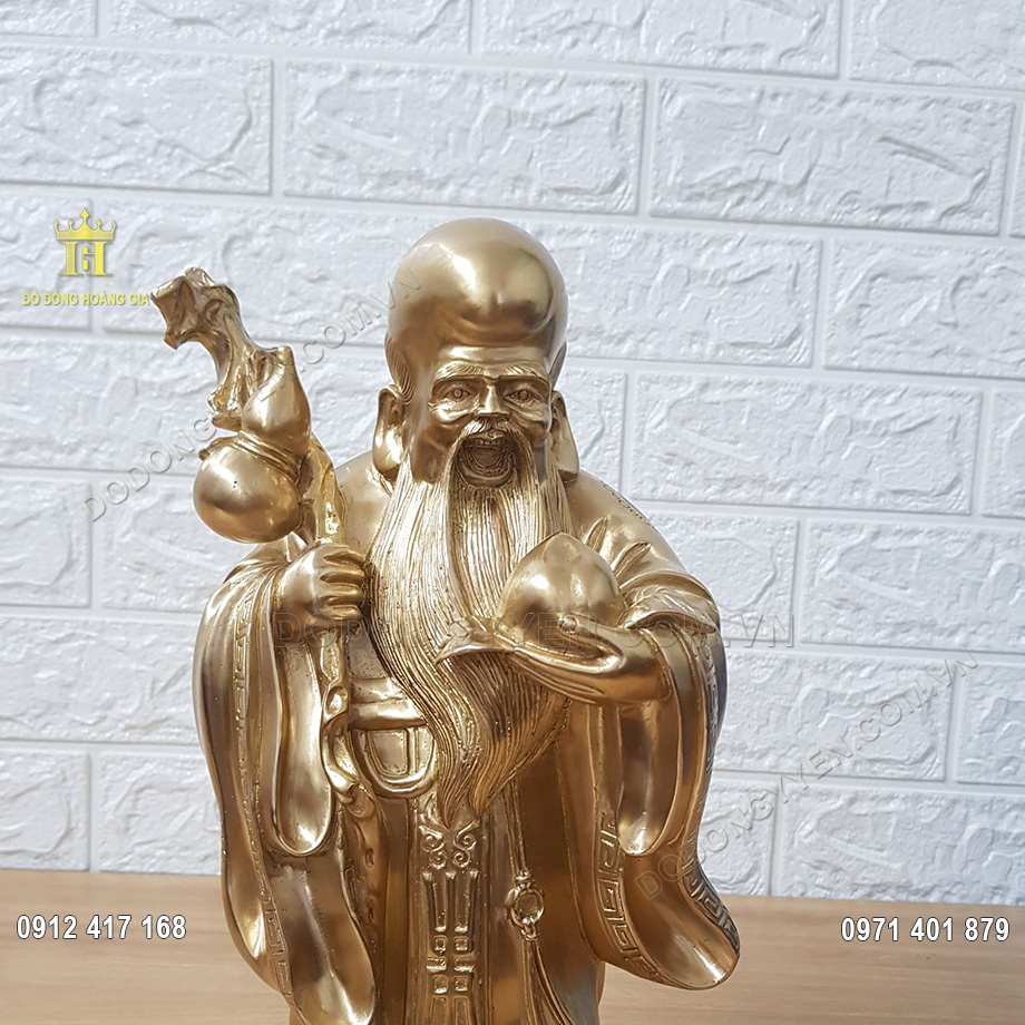 &Ocirc;ng Thọ được đ&uacute;c theo d&aacute;ng đứng, với tay tr&aacute;i cầm tr&aacute;i đ&agrave;o, biểu tượng cho sự trường thọ